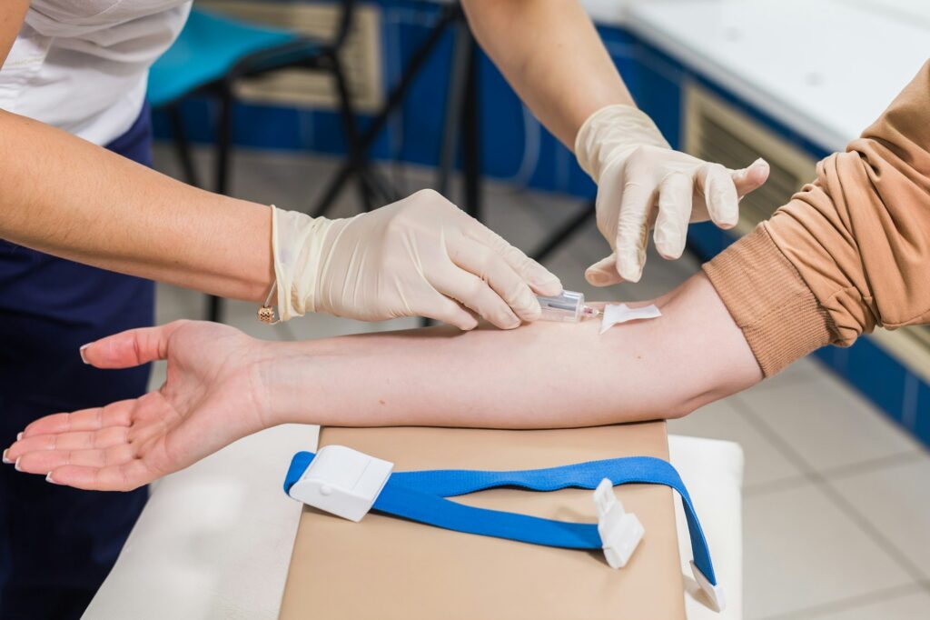 a person injecting a person's arm