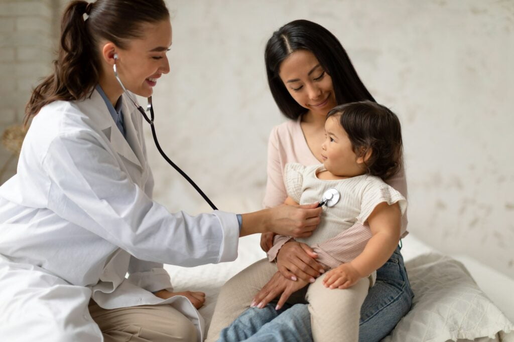 a woman and a baby with a stethoscope