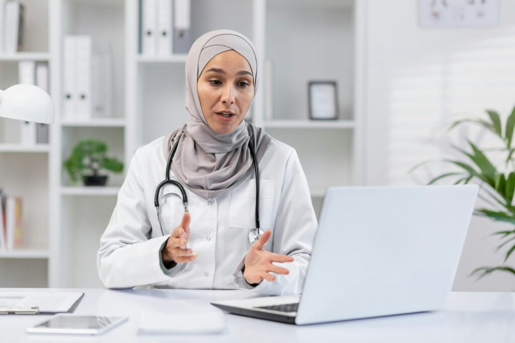 a woman wearing a headscarf and a white coat